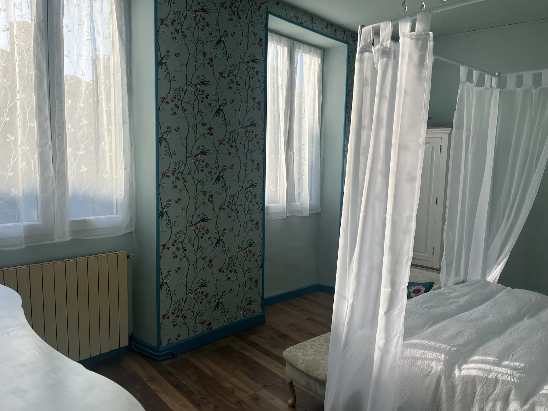 Pink four-poster bedroom at La Belle Maison Rose